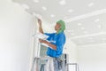 A Thai worker is renewing house`s ceiling and painting it again. Hua Hin, Thailand August 3, 2018