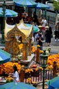 Thai worshippers give offerings and seek blessings at four headed Erawan shrine Bangkok Thailand Royalty Free Stock Photo