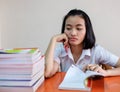 Thai young adult woman student in uniform reading a book Royalty Free Stock Photo