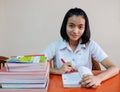 Thai young adult woman student in uniform reading a book Royalty Free Stock Photo