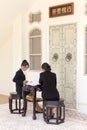 Thai young women sitting on Chinese style furniture in Phuket town, Thailand Royalty Free Stock Photo