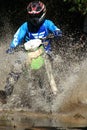 Motocross men, Enduro ride through water splashing in canals,