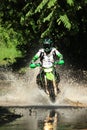 Motocross men, Enduro ride through water splashing in canals,