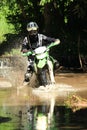 Motocross men, Enduro ride through water splashing in canals,