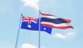 Thailand and Australia, two flags waving against blue sky Royalty Free Stock Photo