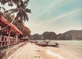 Thailand autumn beach pier: boats at ocean coast waterfront. Water transport at mountain Asia island Royalty Free Stock Photo