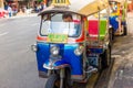 Thailand, Bangkok -Feb 02, 2019: Tuk tuk or taxi driver parking his car beside the road at siamsquare while another motion blur Royalty Free Stock Photo
