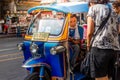 Thailand, Bangkok -Feb 02, 2019: Tuk tuk or taxi driver parking his car beside the road at siamsquare while another motion blur Royalty Free Stock Photo