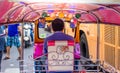 Thailand, Bangkok -Feb 02, 2019: Tuk tuk or taxi driver parking his car beside the road at siamsquare while another motion blur Royalty Free Stock Photo