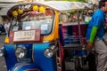 Thailand, Bangkok -Feb 02, 2019: Tuk tuk or taxi driver parking his car beside the road at siamsquare while another motion blur Royalty Free Stock Photo