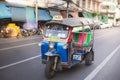 Thailand, Bangkok -Feb 02, 2019: Tuk tuk or taxi driver parking his car beside the road at siamsquare while another motion blur Royalty Free Stock Photo