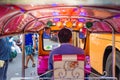 Thailand, Bangkok -Feb 02, 2019: Tuk tuk or taxi driver parking his car beside the road at siamsquare while another motion blur Royalty Free Stock Photo