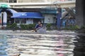 Thailand, Bangkok - November 2011:funny kids swim in a plastic box on the flooded streets