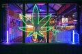 Bright neon signage of a cannabis cafe along busy Silom Road, near Sala Daeng BTS Station, Bangkok