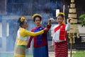 A teacher is teaching Thai dance to students in a Thai style house