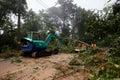 Thailand, Chiangmai, November 02 2022, a blockage on a mountain road. An excavator cleans up fallen trees after a