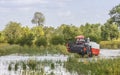 Thailand combine harvesters in rice field water