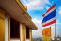 Thailand and Dharmachakra flags on the top of the phu khao thong or golden mountain of wat saket, or the golden mount temple.