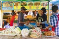 A snack vendor prepares food for sale near Patong beach in Phuket