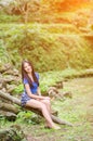 Asian girl sit down path in Bamboo forest