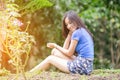 Asian girl sit down path in Bamboo forest