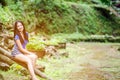 Asian girl sit down path in Bamboo forest