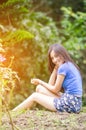 Asian girl sit down path in Bamboo forest