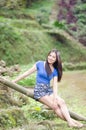 Asian girl sit down path in Bamboo forest