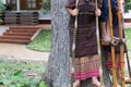 Thailand hill tribe standing on bamboo showing traditional dance