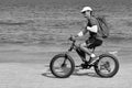 Monochrome photography. A tourist rides a Bicycle on the beach. sea Cycling.