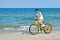 A tourist rides a Bicycle on the beach. sea Cycling. Asian athlete of the sea