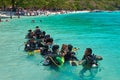 THAILAND, ISLAND CORAL, MARCH 19, 2018 - Group chinese tourists learns to swim with scuba. Coach shows how to use breathing system