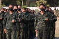 Thailand, 11 Jan 2022, a group of male soldiers wearing masks, stand in line for military training outdoors in the morning.