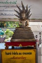 Thailand; Jan 2020: Statue of Buddha in Saturday position, seated in a full lotus position, protected by the Naga King, covered Royalty Free Stock Photo