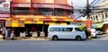 Bronze or gray van and motorcycle parked in front of Dim sum food restaurant