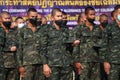 Thailand, January 11, 2022. A group of male soldiers wearing masks stand in line for military training outdoors in the morning.