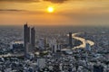 Skyscraper Buildings along curve of Chao Phraya River at Sunset with Orange Sky, Bangkok Royalty Free Stock Photo