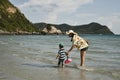 Mom and son playing together on the beach at Namsai beach Sattahip District, Thailand.