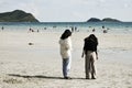 Two women standing on the beach together at Namsai beach Sattahip District Thailand