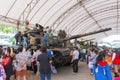 Family and children enjoy fun with military tanks guns and canon army weapons show Royalty Free Stock Photo