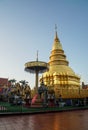 golden Haripunchai Pagoda in temple, the famous destination and tourist attraction in the North of Thailand with sunset sky in win
