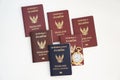 Thailand official passport, Thailand passport and watch on the bright background. Immigration and emigration concept.