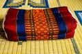 Thailand old backrest pillow on mat. Royalty Free Stock Photo