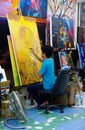 Thailand: painter paints studio yellow