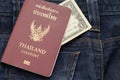 thailand passport and dollar cash puting on blue jean pants,this image for fashion and travel Royalty Free Stock Photo