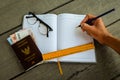 Thailand passport with money, yellow ruler, hand with pencil