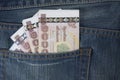 Thailand passport and Thai money in jeans pocket Royalty Free Stock Photo