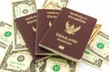 Thailand passport on U.S. Currency bank note. Royalty Free Stock Photo