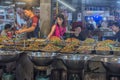 People and a variety of diverse dishes of Thai cuisine on the ni Royalty Free Stock Photo