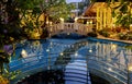 Swimming pool surrounded by a beautiful park of flowering trees at the Amaya Beach Resort and Spa Phuket Royalty Free Stock Photo